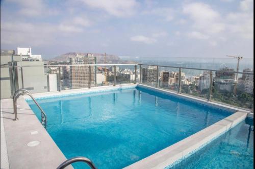 a swimming pool on the roof of a building at Inca inn apartments in Lima