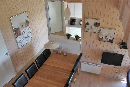 a dining room with a table and chairs and a television at FY292-Faaborg-Mosegarden-40 in Nabbe