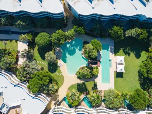an overhead view of a house with a pool and trees at Cotton Beach Apartment 33 With Pool Views in Casuarina