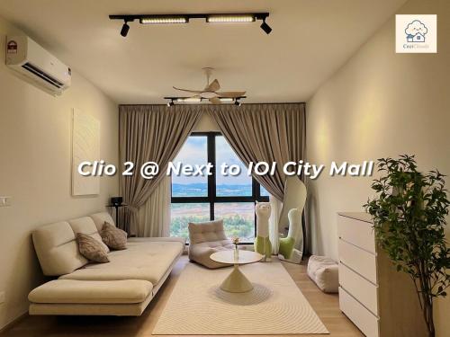 a living room with a couch and a table at Calm MUJI-Inspired Home - Stunning Sunset View - Steps To IOI City Mall - Your Best Urban Retreat in Putrajaya