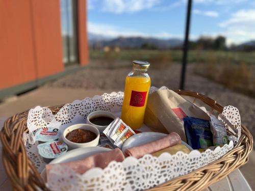 una cesta llena de comida y una botella de zumo en Eco Lodge - Campos de artaza, en Belén