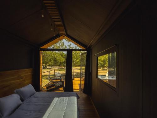 a small room with a bed and a window at Amazing cabin in Samalayuca in Samalayuca