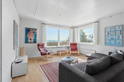 a living room with a couch and two chairs at FY316-Hesselager-Syrenvej-8 in Hesselager