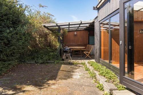 an outdoor patio with a table and a pergola at FY316-Hesselager-Syrenvej-8 in Hesselager
