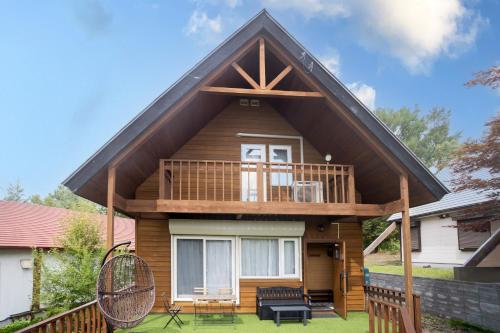 a small house with a gambrel roof at LAKE TOYA PREMIUM CABIN in Lake Toya
