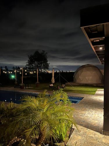 a domed tent is lit up at night at Quinta Paco de Lucía in Yaruqui