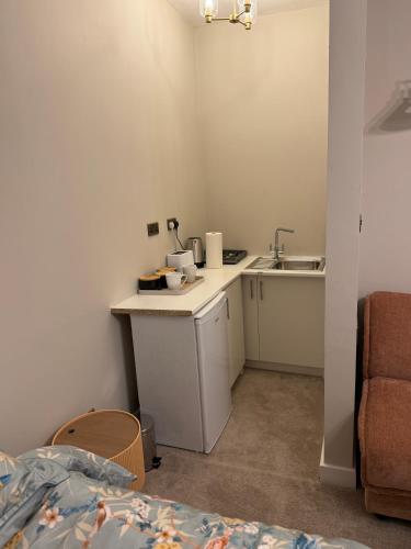 a small kitchen with a sink and a counter top at Double Deluxe Centre Apartment- Free Parking - Self Check-In - Cctv in Huddersfield