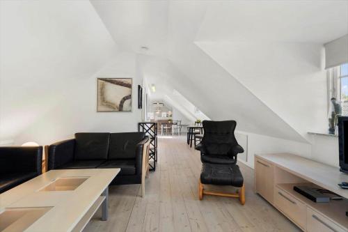 a living room with a couch and a table at FY278-Tommerup-Tobovej-80 in Tommerup