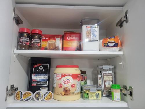 a pantry filled with lots of food and drinks at Entire Basement Suite in Bonavista in Winnipeg
