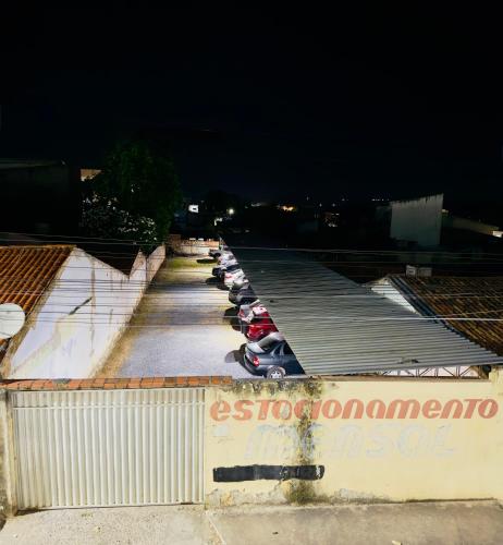 a row of parked cars in a parking lot at night at Serra Flat in Tianguá