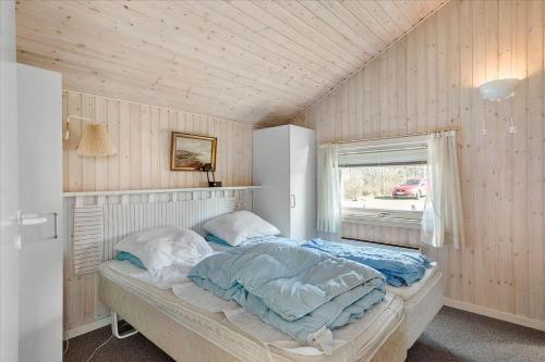 a bedroom with a bed in a room with a window at FY137-Middelfart-Altairvej-17 in Middelfart
