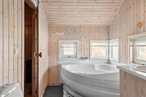 a large white tub in a bathroom with two sinks at FY137-Middelfart-Altairvej-17 in Middelfart
