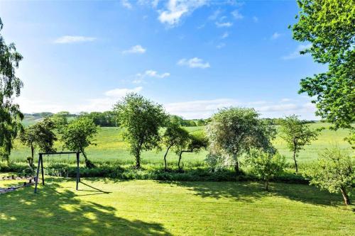 a park with a swing in the middle of a field at FY175-Asperup-Sommerlandsvej-4 in Asperup