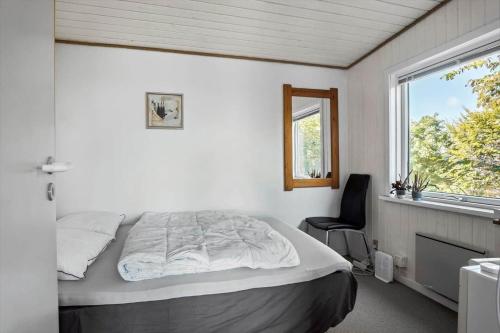 a bedroom with a large bed and a window at FY155-Middelfart-Daemningen-99 in Middelfart