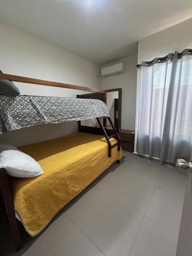 a bedroom with a bunk bed and a window at Apartamento en Zona Playa Cerritos in Mazatlán