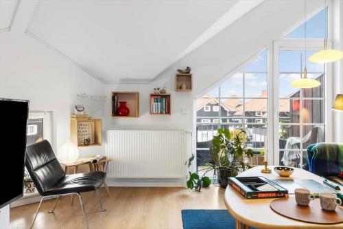 a living room with a table and a large window at FY382-Bogense-Vestre-Engvej-104-1-tv in Bogense