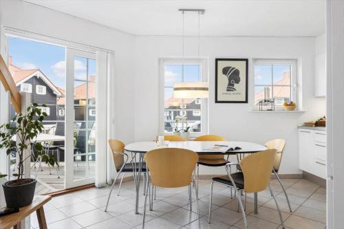 a kitchen and dining room with a table and chairs at FY382-Bogense-Vestre-Engvej-104-1-tv in Bogense