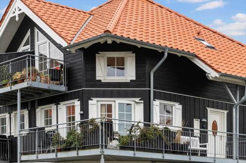 a black house with an orange roof at FY382-Bogense-Vestre-Engvej-104-1-tv in Bogense