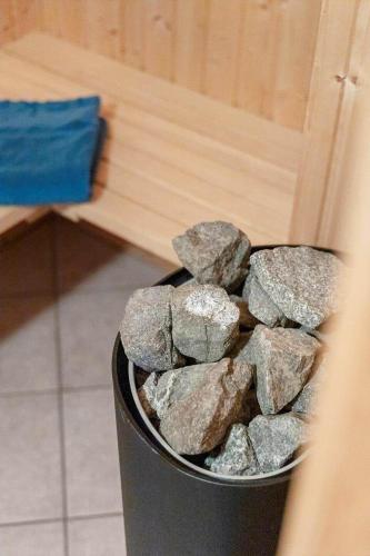a bucket full of rocks sitting next to a wall at FY382-Bogense-Vestre-Engvej-104-1-tv in Bogense
