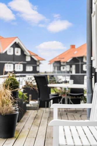 a balcony with a white bench and some buildings at FY382-Bogense-Vestre-Engvej-104-1-tv in Bogense
