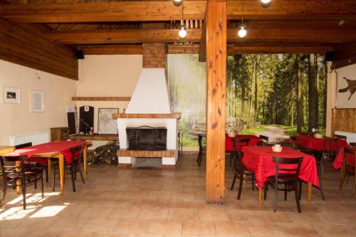 a patio with tables and chairs and a fireplace at Penzion Pod Houskou in Blatce