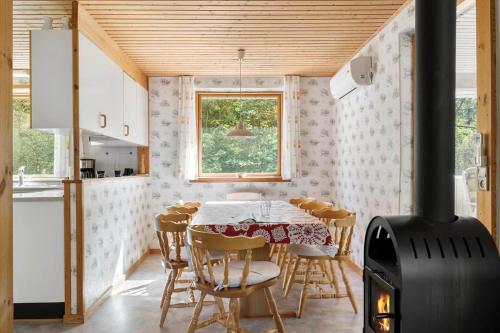 a kitchen and dining room with a wood stove at 2715-Nexo-Munkegardsskoven-32 in Neksø