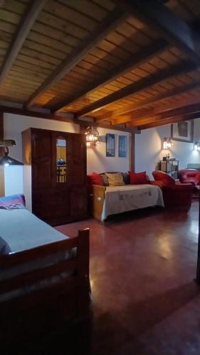 a large room with two beds and a couch at Apart Don Ángel Tandil in Tandil