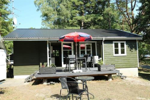 a house with a table and chairs and an umbrella at 6705-Hasle-Klympen-10 in Hasle
