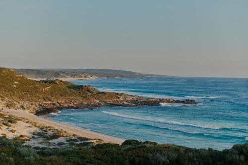 a view of a beach with the ocean at Melo Beach Escape - Luxury Gnarabup beach house in Gnarabup