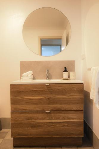 a bathroom with a sink and a mirror at Melo Beach Escape - Luxury Gnarabup beach house in Gnarabup