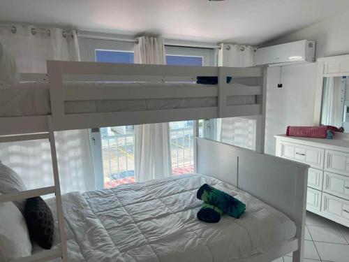 a bedroom with a bunk bed with a teddy bear on it at Villas de Playa II in Jayuya