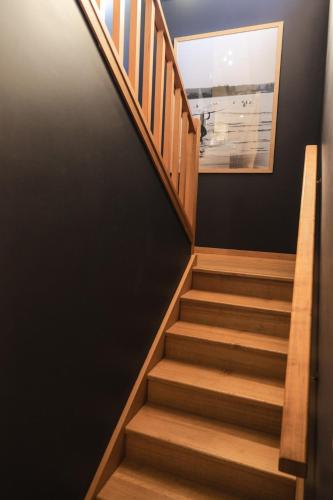a staircase in a house with a picture on the wall at Melo Beach Escape - Luxury Gnarabup beach house in Gnarabup