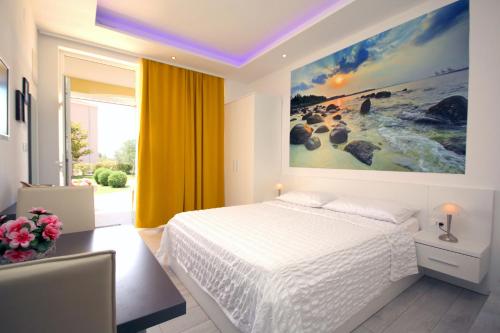 a bedroom with a bed and a painting on the wall at Villa Principessa Podstrana in Podstrana