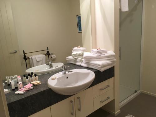 a bathroom with a sink and a mirror at Puka Heights in Pauanui
