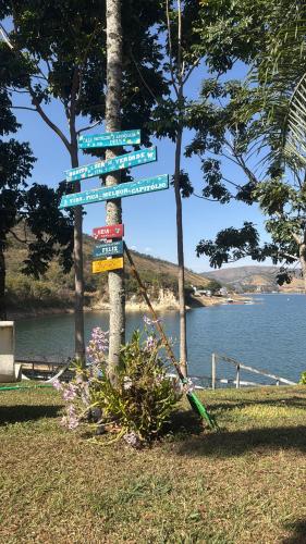 a street sign with many signs on a pole at Nosso Recanto Pérola in Capitólio