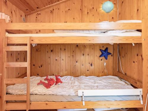 Una litera con dos literas en una habitación de madera. en 6 person holiday home in Gedser, en Gedser