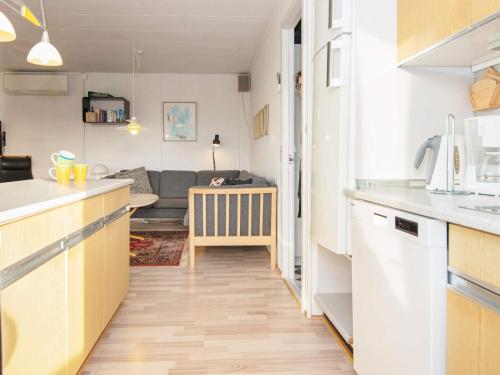 a kitchen and a living room with a couch at 6 person holiday home in Lemvig in Lemvig