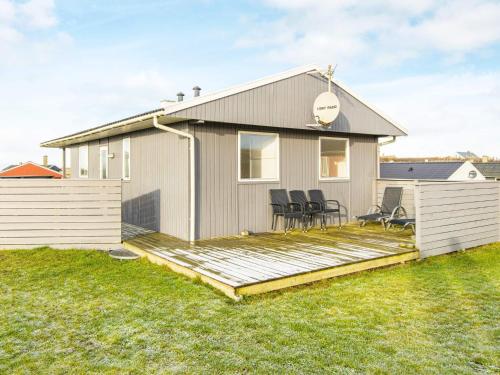 a house with a deck with chairs on it at 6 person holiday home in Lemvig in Lemvig