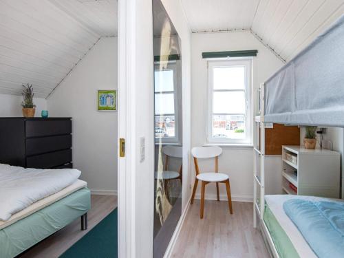 a bedroom with a bunk bed and a desk at 5 person holiday home in Rømø-By Traum in Sønderby