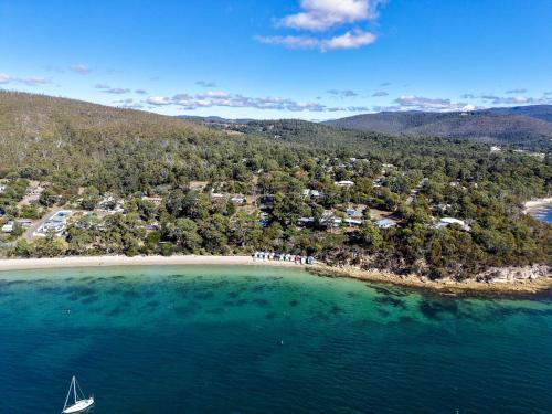 an aerial view of a beach with a boat in the water at Coningham Beach House - 3 Bedrooms in Coningham