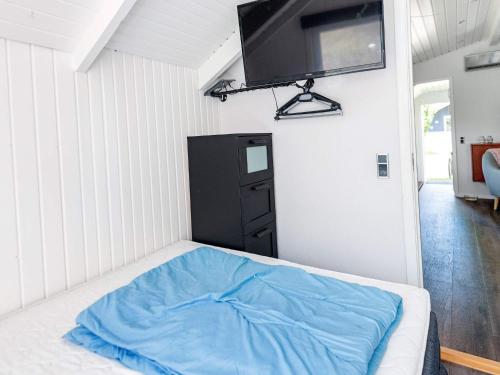 a bedroom with a bed with a tv on the wall at 4 person holiday home in Hovborg-By Traum in Hovborg