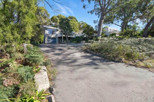 an empty road in front of a house at Coningham Beach House - 3 Bedrooms in Coningham
