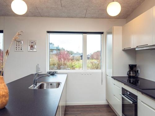 a kitchen with a sink and a window at 14 person holiday home in Glesborg in Glesborg