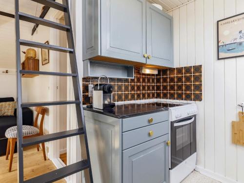 a kitchen with a ladder in a tiny house at 4 person holiday home in Karrebæksminde-By Traum in Karrebæksminde