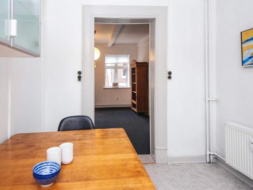 a dining room with a table and a hallway at Charming Retreat by Fjord - By Traum Ferienwohnungen in Ringkøbing