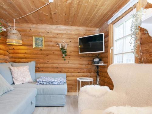 a living room with a couch and a tv at 4 person holiday home in Hovborg-By Traum in Hovborg