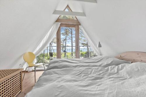 a bedroom with a large bed and a window at 3646-Nexo-Frederiksvej-8 in Neksø