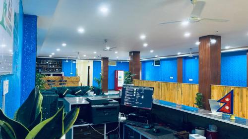 an office with blue walls and a desk with a computer at Hotel Kavya International in Bharatpur