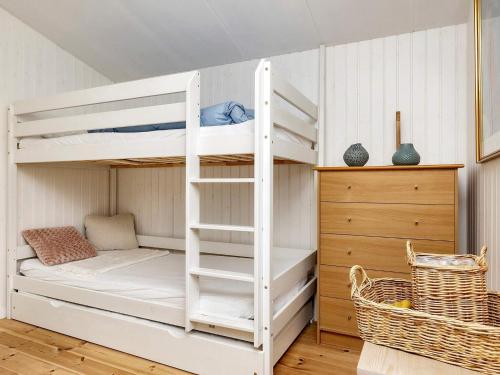 a bunk bed with a ladder in a room at 5 person holiday home in Karrebæksminde in Karrebæksminde