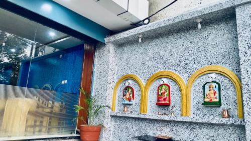 a building with some figurines on the side of it at Hotel Kavya International in Bharatpur